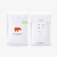 Two coffee packages from 'kiss the hippo' on a white background