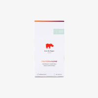 A white rectangular box of kiss the hippo coffee's Fruitopia Blend, featuring a red hippo logo and orange and green accents, set against a plain light grey background.