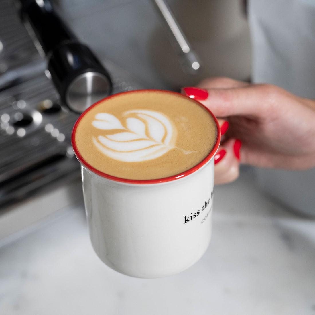 kiss the hippo - person holding a coffee mug