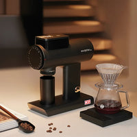 Timemore Sculptor in black beside a V60 pour-over and brewing scale