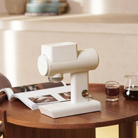 Timemore Sculptor in white on a dining table with books and brewing kit