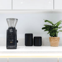 Baratza Encore Coffee Grinder in use with freshly ground coffee