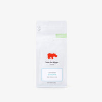 Coffee package with 'Kiss the Hippo' branding on a white background