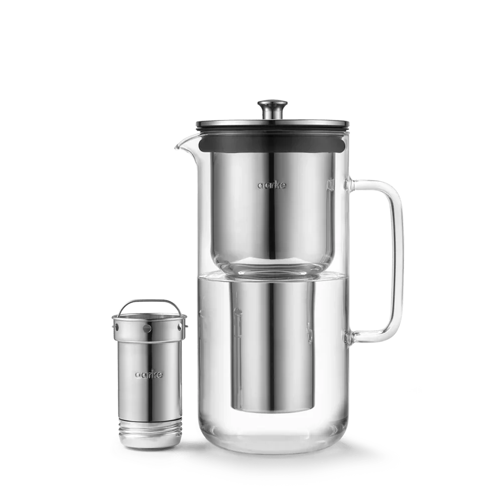 Aarke Water Purifier Jug in glass and stainless steel, shown with its refillable filter cartridge