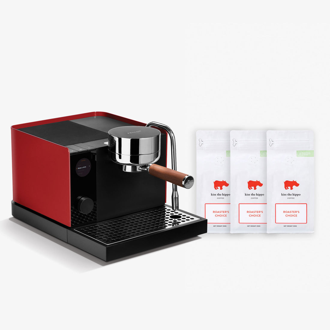 A red and black espresso machine with a chrome portafilter and wooden handle, shown next to three white coffee bean bags labeled 'Koe Die Hopper' on a clean white background.