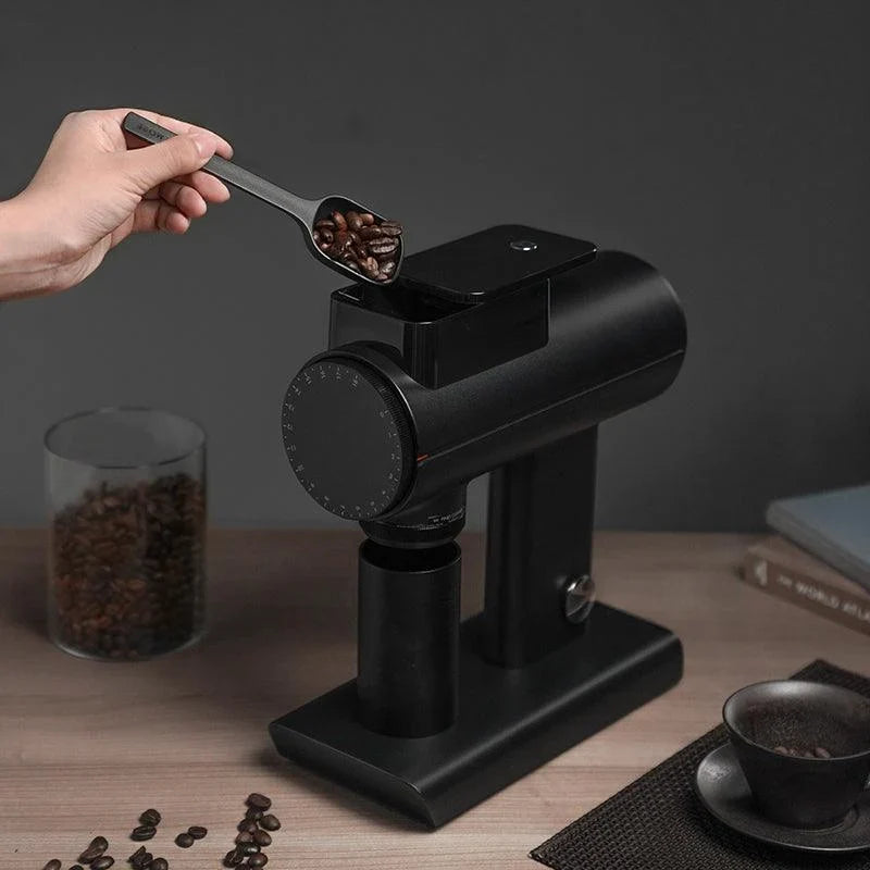 Pouring coffee beans into the hopper of a Timemore Sculptor in black