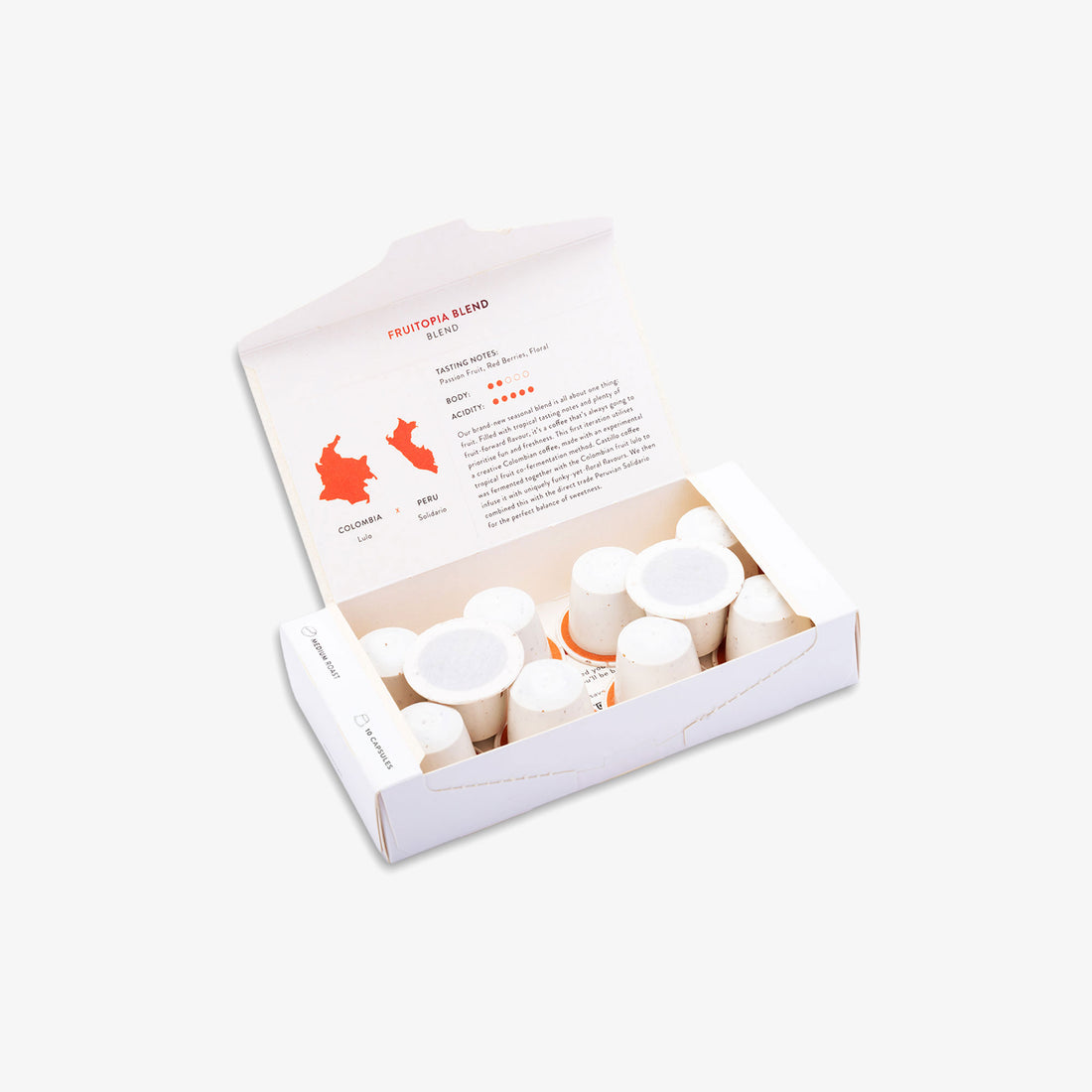 An open white cardboard box containing kiss the hippo coffee pods, photographed on a clean white background. The inside lid has printed text and an orange map graphic.