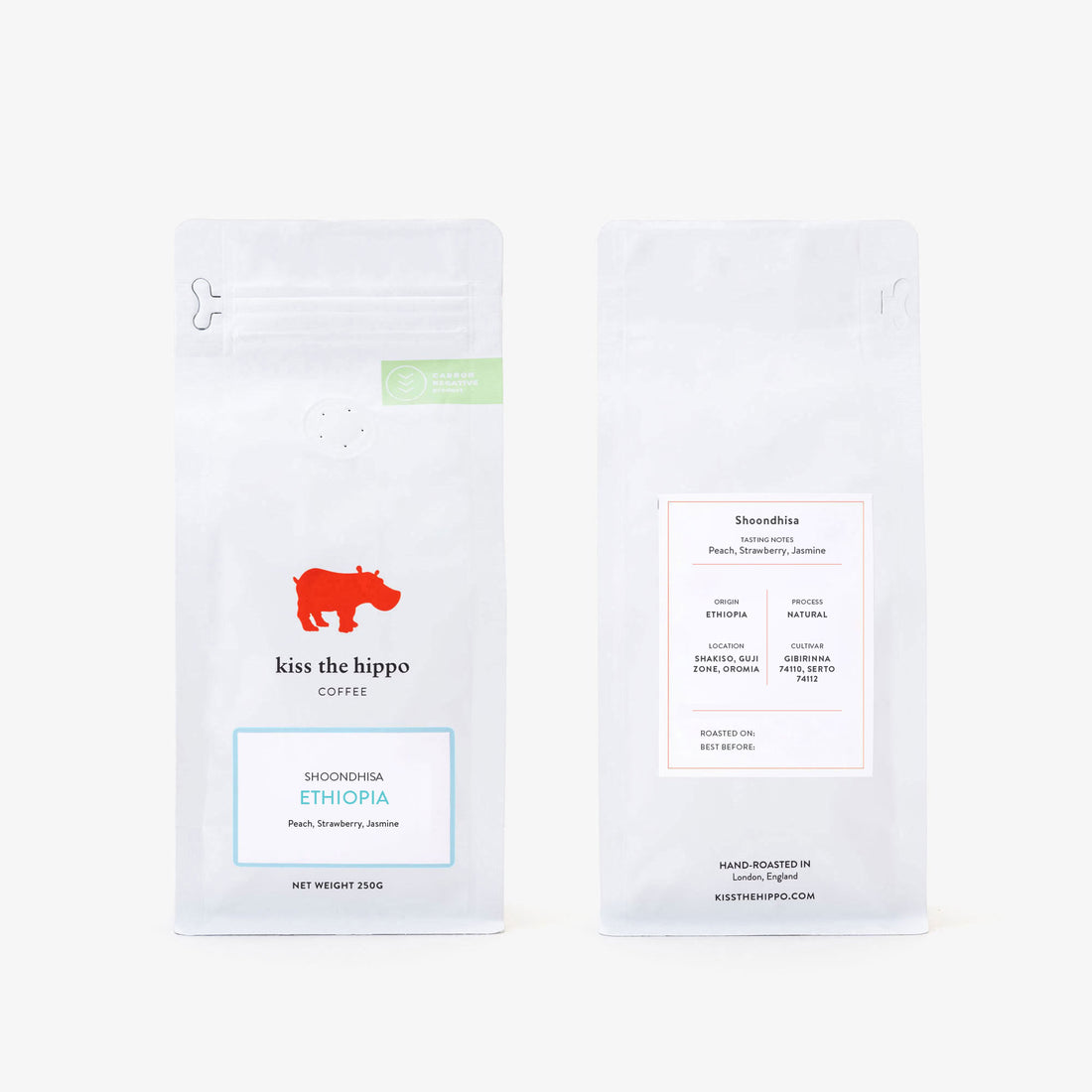 Two white coffee bag packages shown side by side on a light gray background. The left package shows the front with a red hippo logo, the text 'kiss the hippo coffee,' and a blue-bordered label reading 'Jazmin Honduras.