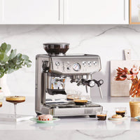 Sage Barista Express Impress Espresso Machine in use brewing espresso with Impress Puck System